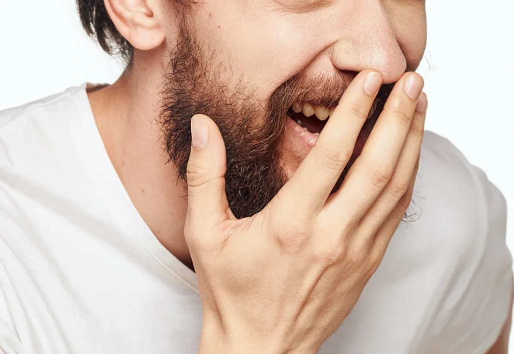 persona che si vergogna di sorridere - centri odontoiatrici massaiu - faccette